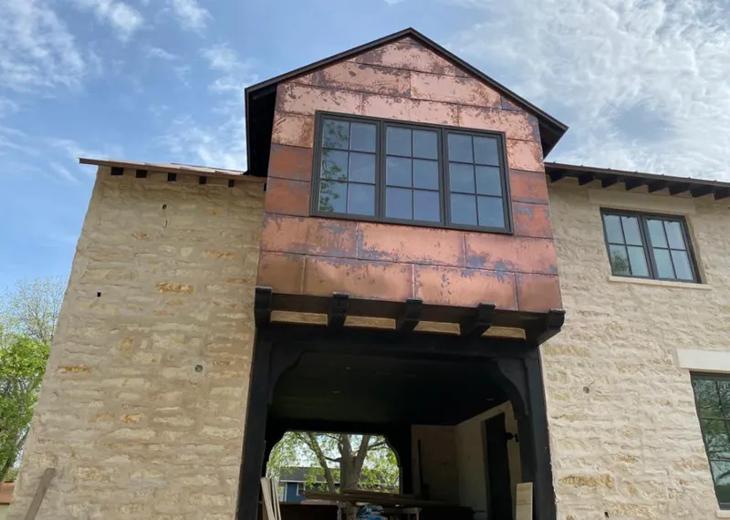 Copper metal panel facade on a stone building for Skylight Installation in Dunn